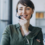 Smiling woman with a headset, representing engagement in podcasting and creative discussions related to fashion and lifestyle.
